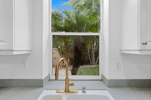 details featuring white cabinetry and sink