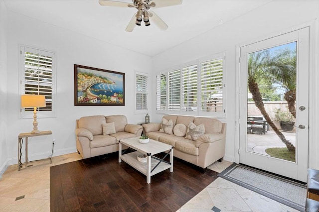 tiled living room with ceiling fan