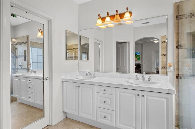 bathroom featuring vanity and a shower with door