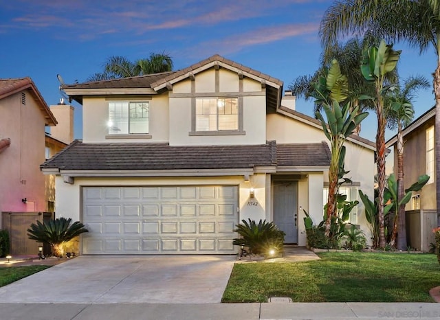 view of front of property with a lawn and a garage