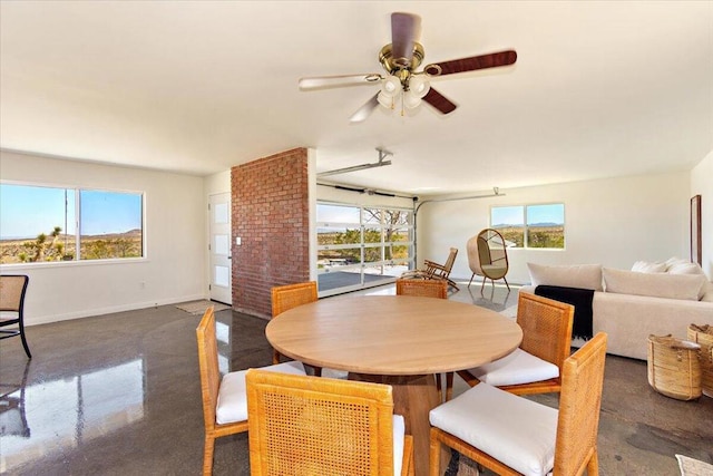 dining space with plenty of natural light and ceiling fan