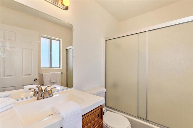 full bathroom featuring vanity, toilet, and combined bath / shower with glass door