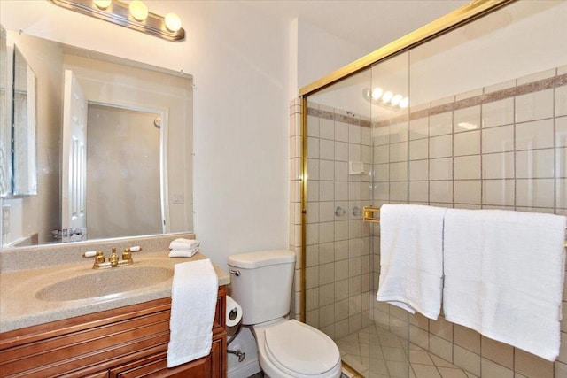 bathroom featuring vanity, toilet, and an enclosed shower