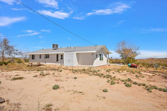 back of house featuring central air condition unit