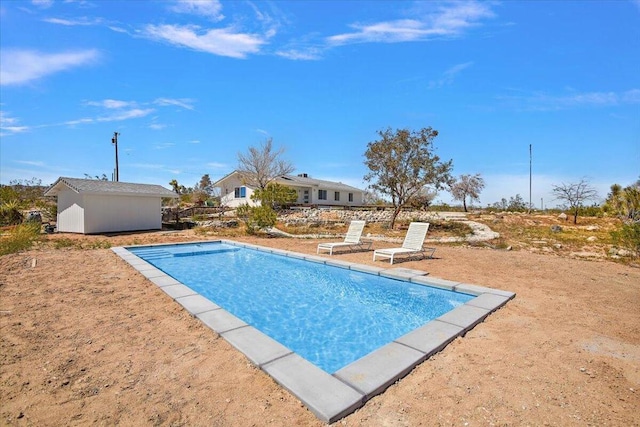 view of swimming pool with an outbuilding