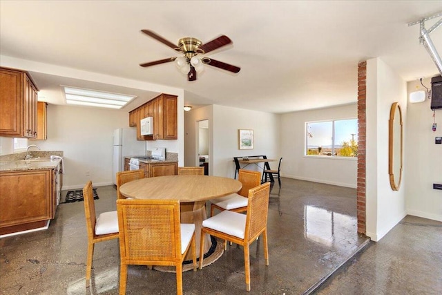 dining space with ceiling fan and sink