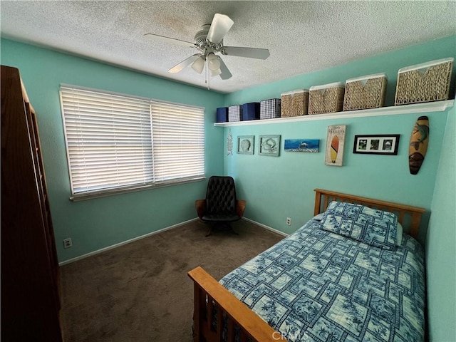 unfurnished bedroom with ceiling fan, a textured ceiling, and dark colored carpet