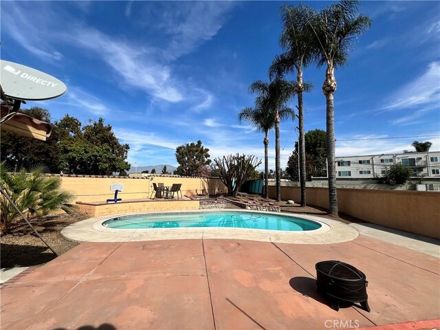 view of swimming pool with a patio