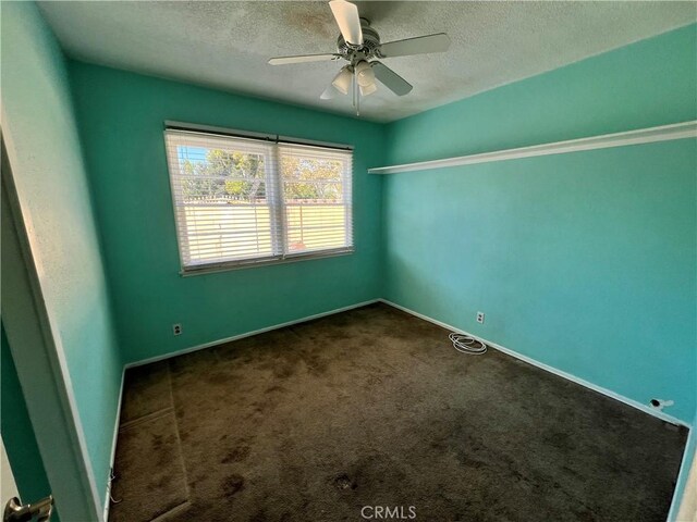 unfurnished room featuring a textured ceiling, ceiling fan, and carpet flooring