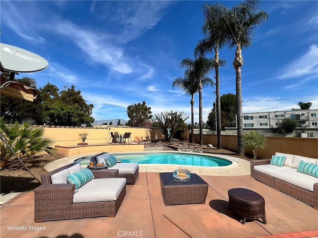 view of pool with an outdoor living space and a patio