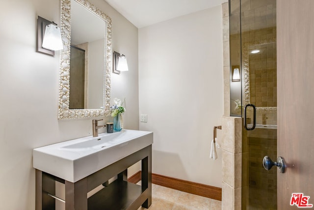 bathroom with tile patterned floors and a shower with shower door