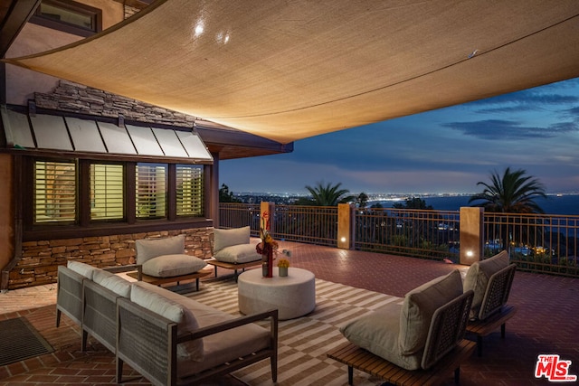 deck at dusk with an outdoor living space