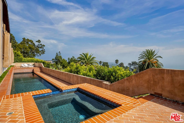 view of pool featuring an in ground hot tub