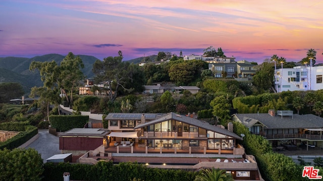 aerial view at dusk featuring a mountain view