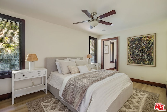 bedroom with ceiling fan and hardwood / wood-style flooring