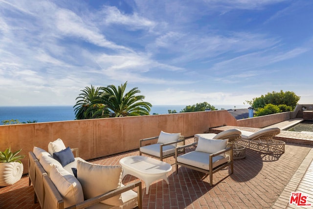 view of patio with a water view and an outdoor hangout area