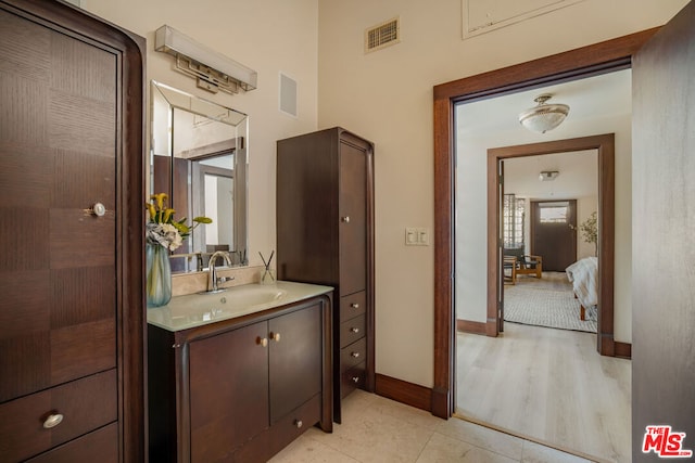 bathroom with hardwood / wood-style flooring and vanity