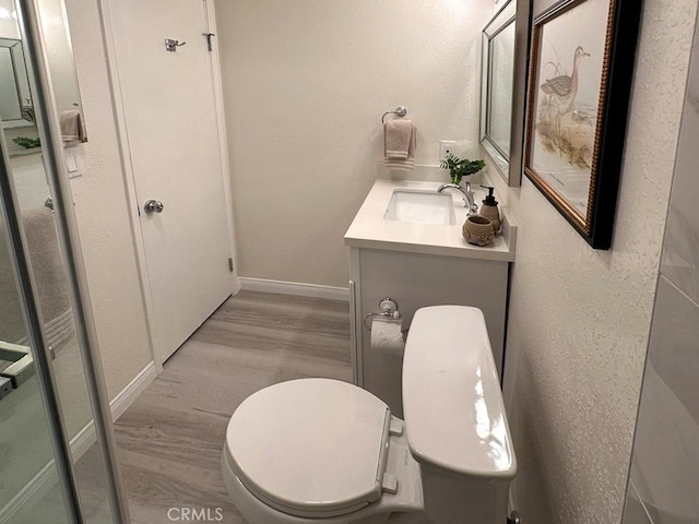 bathroom featuring hardwood / wood-style floors, toilet, and vanity