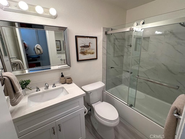 full bathroom featuring vanity, tasteful backsplash, toilet, hardwood / wood-style flooring, and combined bath / shower with glass door