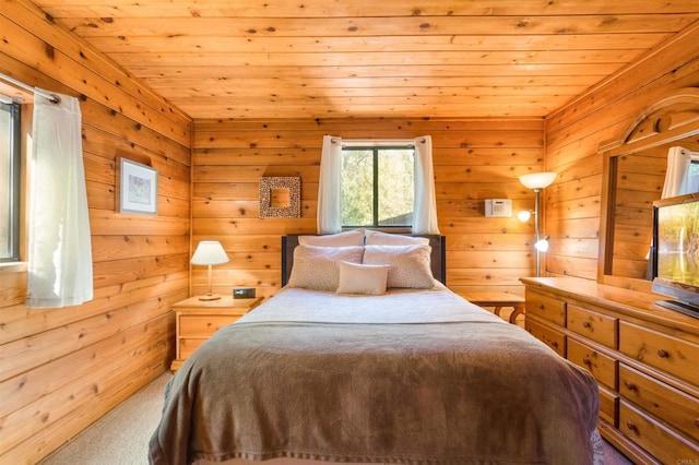 bedroom featuring wood ceiling, carpet floors, and wood walls