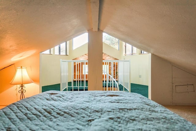 bedroom with carpet floors, lofted ceiling with beams, and a textured ceiling