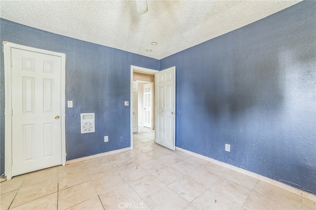 spare room featuring a textured ceiling