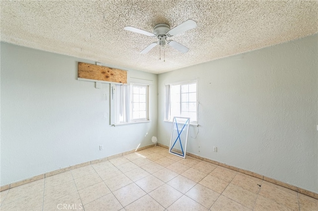 unfurnished room featuring ceiling fan and a textured ceiling