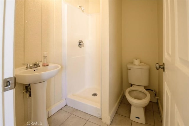 full bathroom with a sink, toilet, a shower stall, and tile patterned flooring