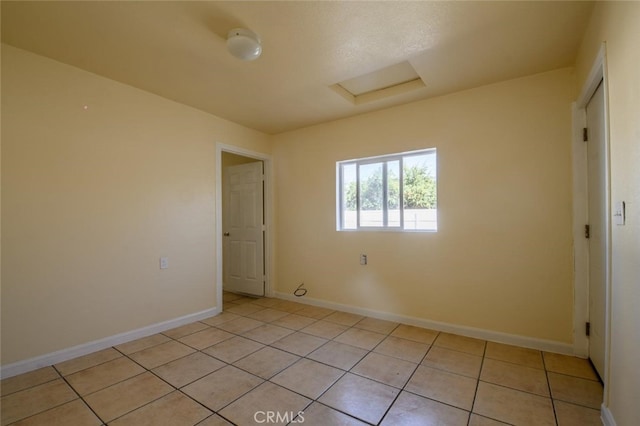 spare room featuring light tile patterned floors