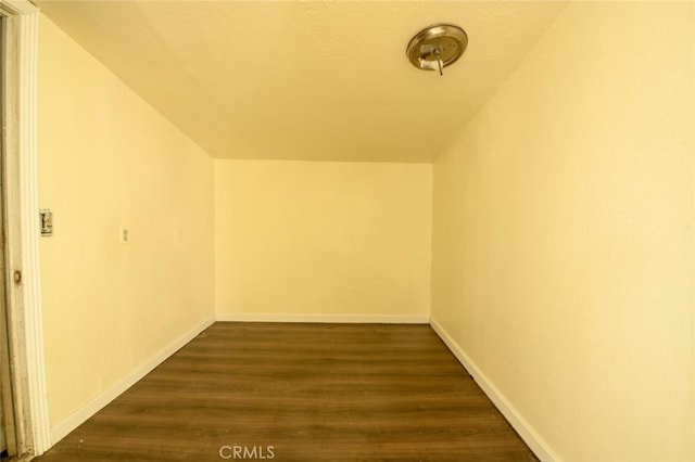 additional living space with dark wood-type flooring