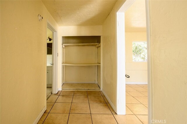 hallway with light tile patterned floors