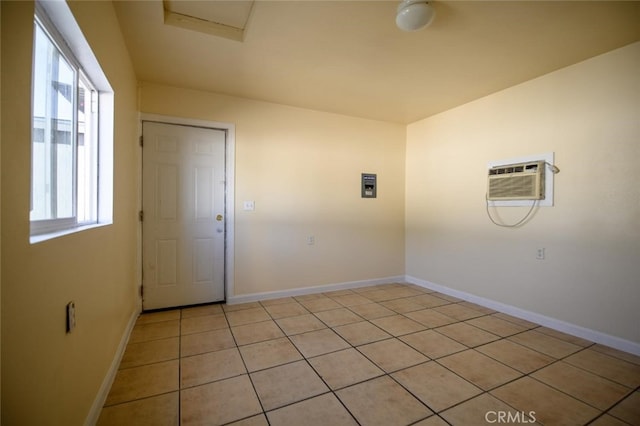 washroom featuring an AC wall unit and light tile patterned floors