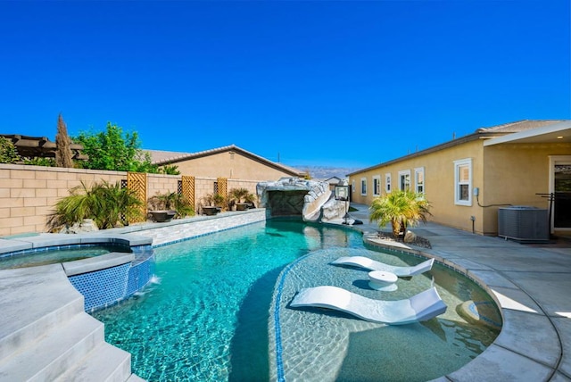 view of swimming pool featuring an in ground hot tub, pool water feature, central AC unit, and a patio area