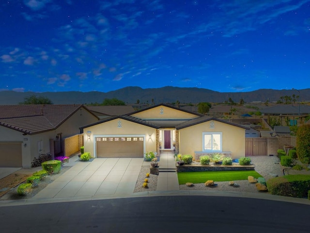 single story home with a mountain view and a garage