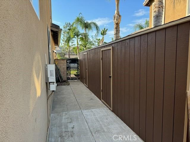 3887 Via Zumaya St, Corona, CA 92881 - view of home's exterior with a gate and stucco siding