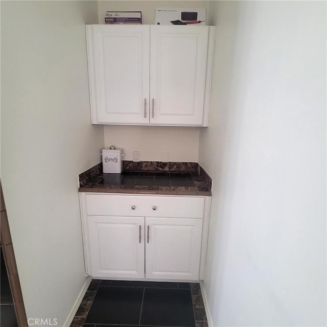 3887 Via Zumaya St, Corona, CA 92881 - bar area with baseboards and dark tile patterned flooring