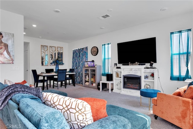 living room with plenty of natural light and carpet floors