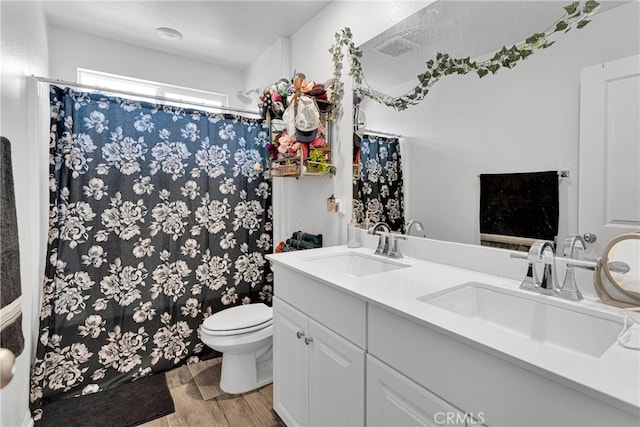 bathroom featuring hardwood / wood-style floors, vanity, and toilet