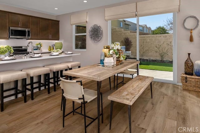 dining area featuring light hardwood / wood-style flooring and sink