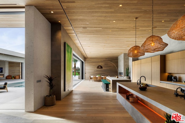 interior space with light wood-type flooring and wooden ceiling