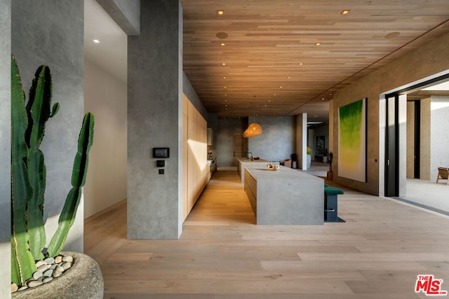 hallway with light hardwood / wood-style floors and wood ceiling