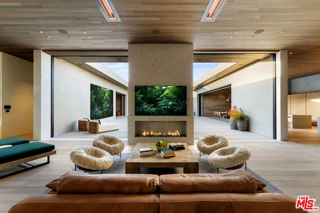 living room with wood ceiling and light hardwood / wood-style flooring