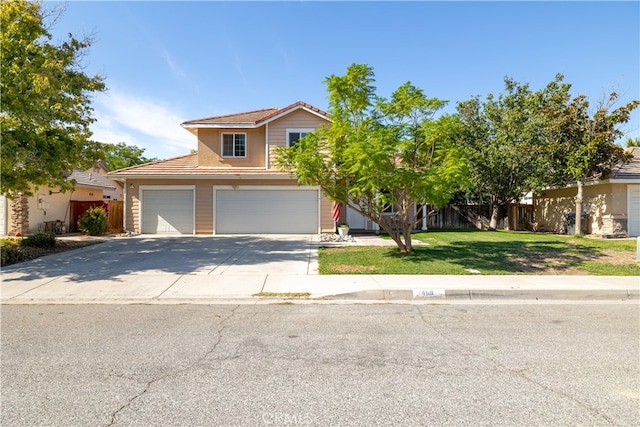 view of front of property with a front yard and a garage