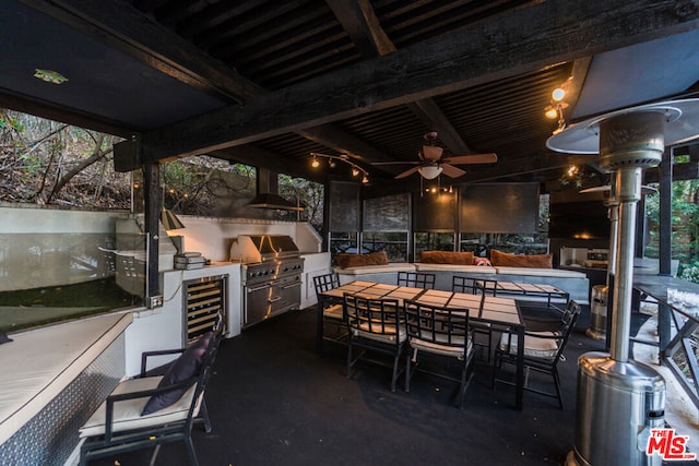 view of patio / terrace featuring a grill, ceiling fan, wine cooler, and exterior kitchen