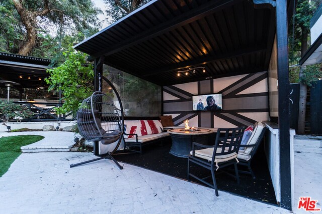 view of patio / terrace featuring an outdoor fire pit