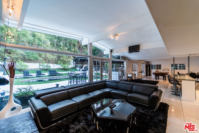 living room featuring lofted ceiling with beams and tile patterned flooring