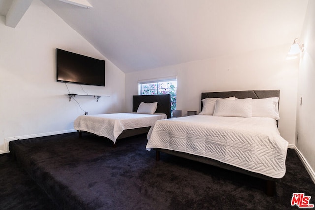 bedroom featuring vaulted ceiling and carpet flooring