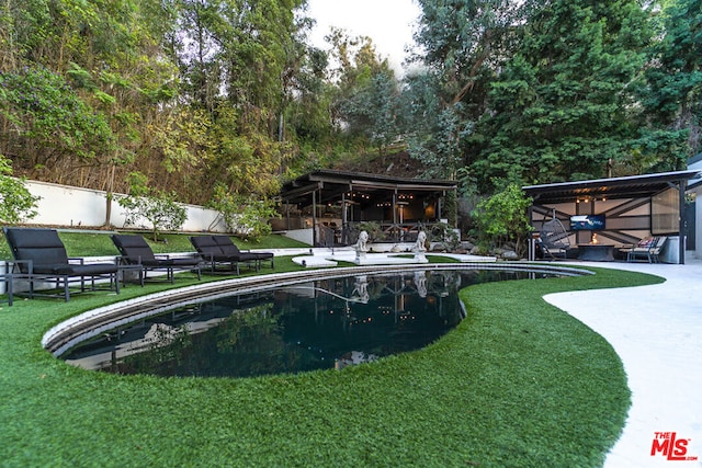 view of pool featuring a yard and a patio