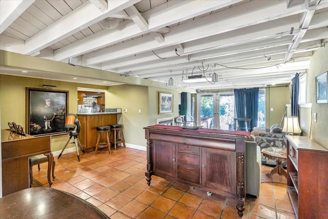 interior space featuring beam ceiling, light tile patterned floors, and french doors