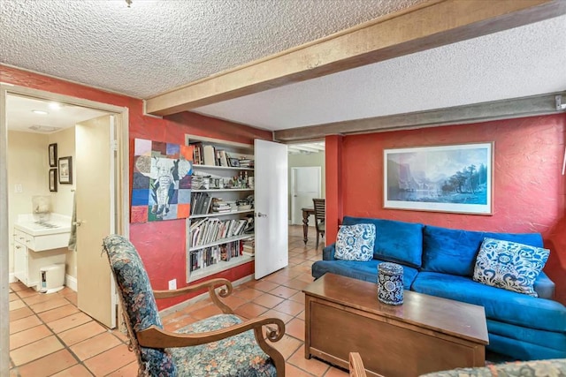 tiled living room featuring beamed ceiling and a textured ceiling